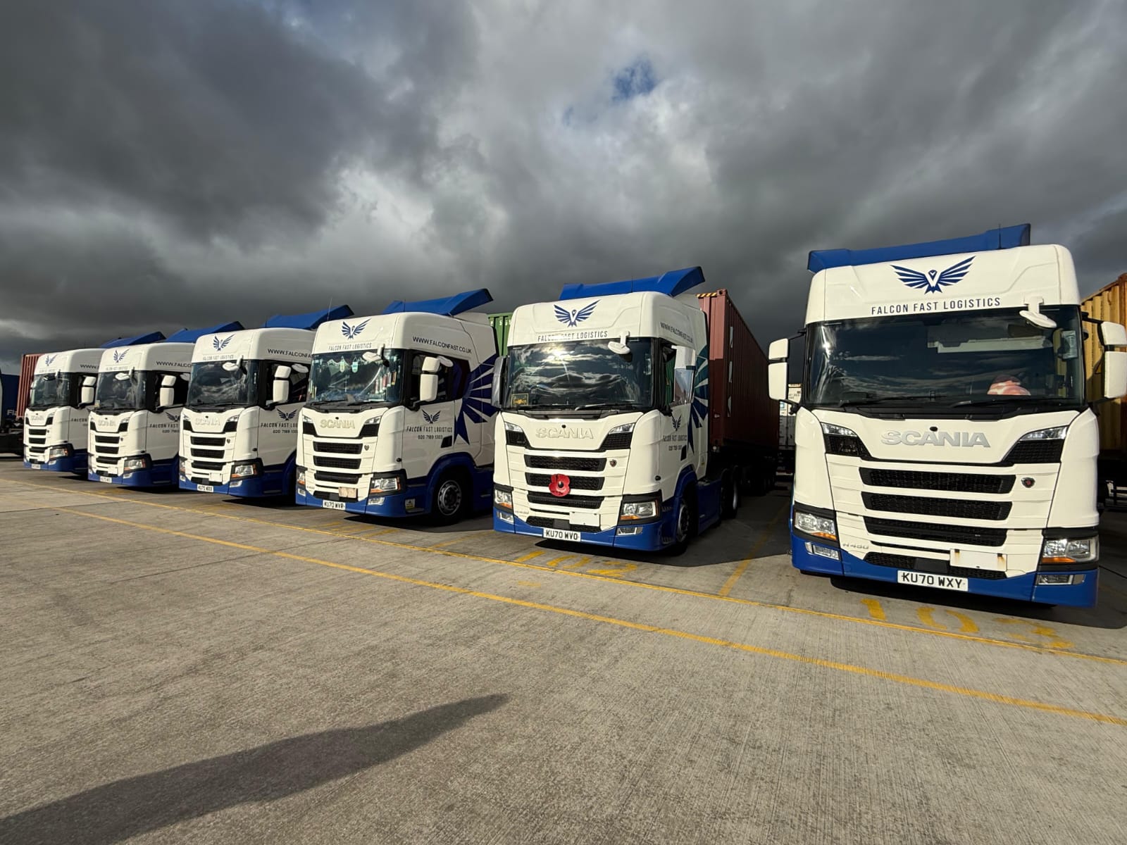 Falcon Fast Logistics Scania fleet lined up under a dramatic sky