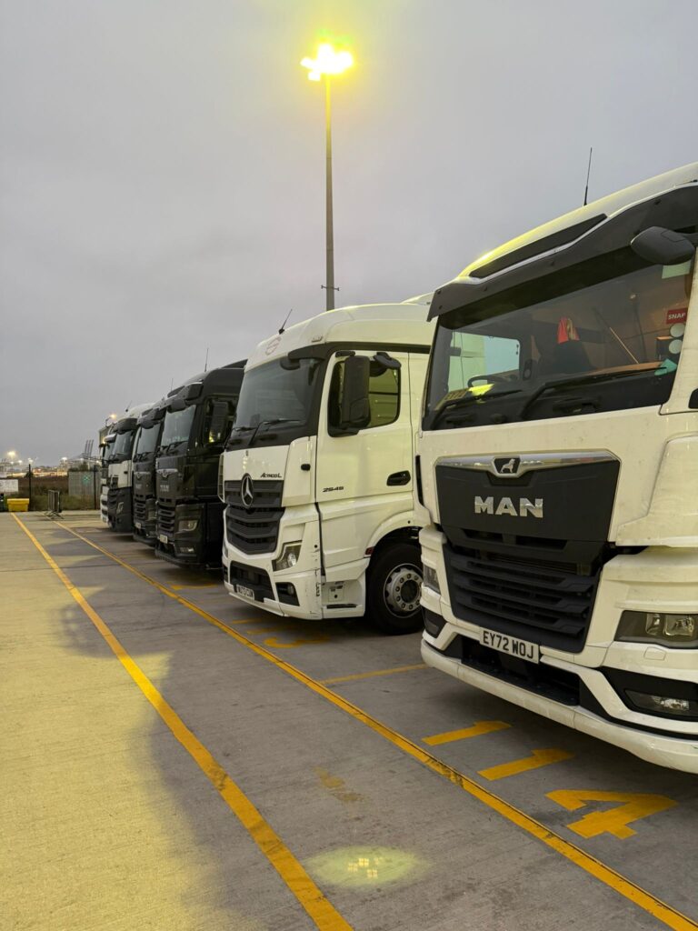 Falcon Fast Logistics fleet lined up at dusk